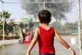 Child playing in the rain falling in the water park Royalty Free Stock Photo