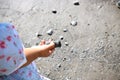 Child playing with rocks on the beach