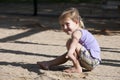 Child playing with sand on the playground Royalty Free Stock Photo