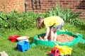 Child playing in a sandpit.