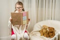 Child playing school teacher with teddy bears at home. Royalty Free Stock Photo