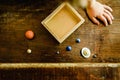 Child playing with small toy planets on an old wooden table Royalty Free Stock Photo