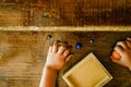 Child playing with small toy planets on an old wooden table Royalty Free Stock Photo