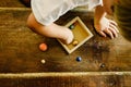 Child playing with small toy planets on an old wooden table Royalty Free Stock Photo