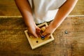 Child playing with small toy planets on an old wooden table Royalty Free Stock Photo