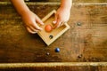 Child playing with small toy planets on an old wooden table Royalty Free Stock Photo