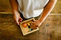 Child playing with small toy planets on an old wooden table Royalty Free Stock Photo