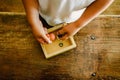 Child playing with small toy planets on an old wooden table Royalty Free Stock Photo