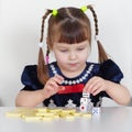 Child playing with small toys at table Royalty Free Stock Photo