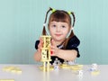 Child playing with small toys at table Royalty Free Stock Photo