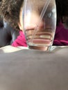 Child playing with smile behind glass showing teeth enlarged