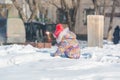 A child is playing in the snow. A child plays in winter with a view from the spen. Royalty Free Stock Photo