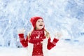 Child playing in snow on Christmas. Kids in winter Royalty Free Stock Photo