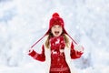 Child playing in snow on Christmas. Kids in winter Royalty Free Stock Photo