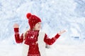 Child playing in snow on Christmas. Kids in winter Royalty Free Stock Photo