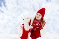 Child playing in snow on Christmas. Kids in winter Royalty Free Stock Photo