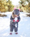 Child playing with snow in winter day