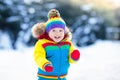 Child playing with snow in winter. Kids outdoors. Royalty Free Stock Photo