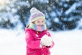 Child playing with snow in winter. Kids outdoors. Royalty Free Stock Photo