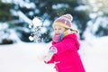 Child playing with snow in winter. Kids outdoors. Royalty Free Stock Photo