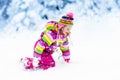 Child playing with snow in winter. Kids outdoors. Royalty Free Stock Photo