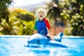 Child in swimming pool. Kid on inflatable float Royalty Free Stock Photo