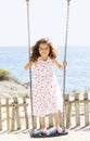 Child playing swing on vacation Royalty Free Stock Photo