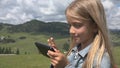 Child Playing Tablet Outdoor in Park, Kid use Smartphone on Meadow Girl in Grass Royalty Free Stock Photo