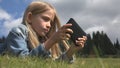 Child Playing Tablet Outdoor in Park, Kid use Smartphone on Meadow Girl in Grass