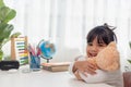 Child playing with teddy bear. Asian little girl hugging his favorite toy. Kid and stuffed animal at home Royalty Free Stock Photo