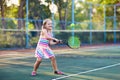 Child playing tennis on outdoor court Royalty Free Stock Photo