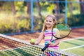 Child playing tennis on outdoor court Royalty Free Stock Photo