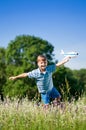 Child playing toy airplane on field Royalty Free Stock Photo