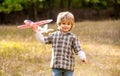Child playing with toy airplane. Happy child playing. Happy child playing outdoors. Happy boy play airplane. Little boy