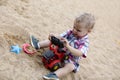 Child playing with toy bulldozer