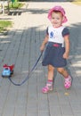 Child playing with a toy car