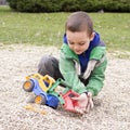Child playing with toy digger Royalty Free Stock Photo