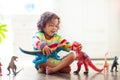 Child playing with toy dinosaurs. Kids toys Royalty Free Stock Photo