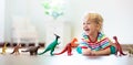 Child playing with toy dinosaurs. Kids toys Royalty Free Stock Photo