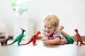 Child playing with toy dinosaurs. Kids toys Royalty Free Stock Photo