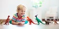 Child playing with toy dinosaurs. Kids toys Royalty Free Stock Photo