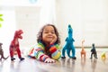 Child playing with toy dinosaurs. Kids toys Royalty Free Stock Photo