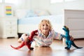 Child playing with toy dinosaurs. Kids toys Royalty Free Stock Photo