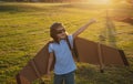 Child playing with toy jetpack. Child pilot astronaut or spaceman dreams of flight. Aviator boy flying with a cardboard Royalty Free Stock Photo