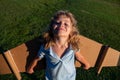 Child playing with toy jetpack. Child pilot astronaut or spaceman dreams of flight. Top view of aviator boy flying with