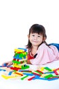 Child playing toy wood blocks, isolated on white background. Royalty Free Stock Photo