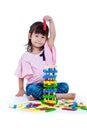 Child playing toy wood blocks, isolated on white background. Royalty Free Stock Photo