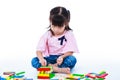 Child playing toy wood blocks, isolated on white background. Royalty Free Stock Photo