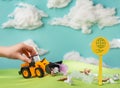 Child playing with a truck collecting garbage on the lawn Royalty Free Stock Photo