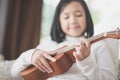 Child playing ukulele Royalty Free Stock Photo